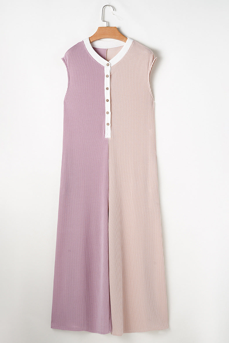 Two-tone dress with a buttoned front on a hanger against a white background
