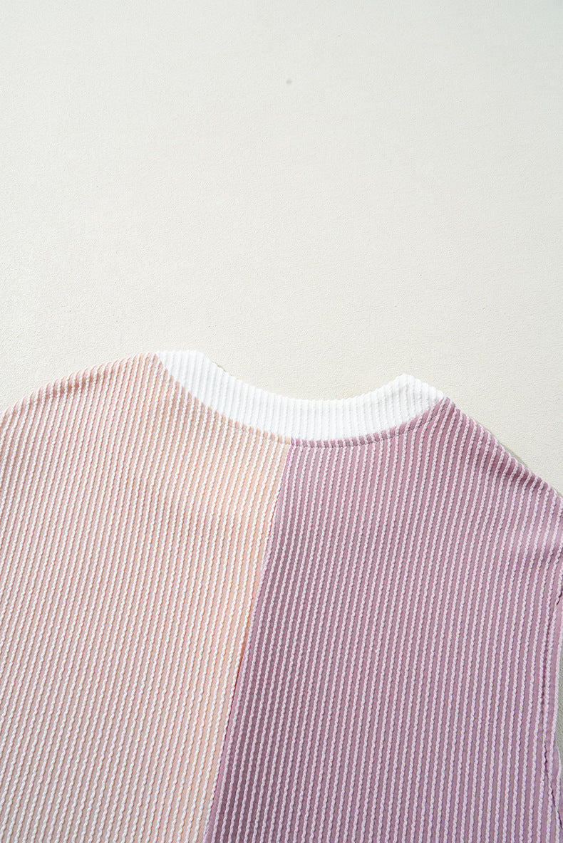 Close-up of a striped shirt with pink and purple pattern on a light gray background