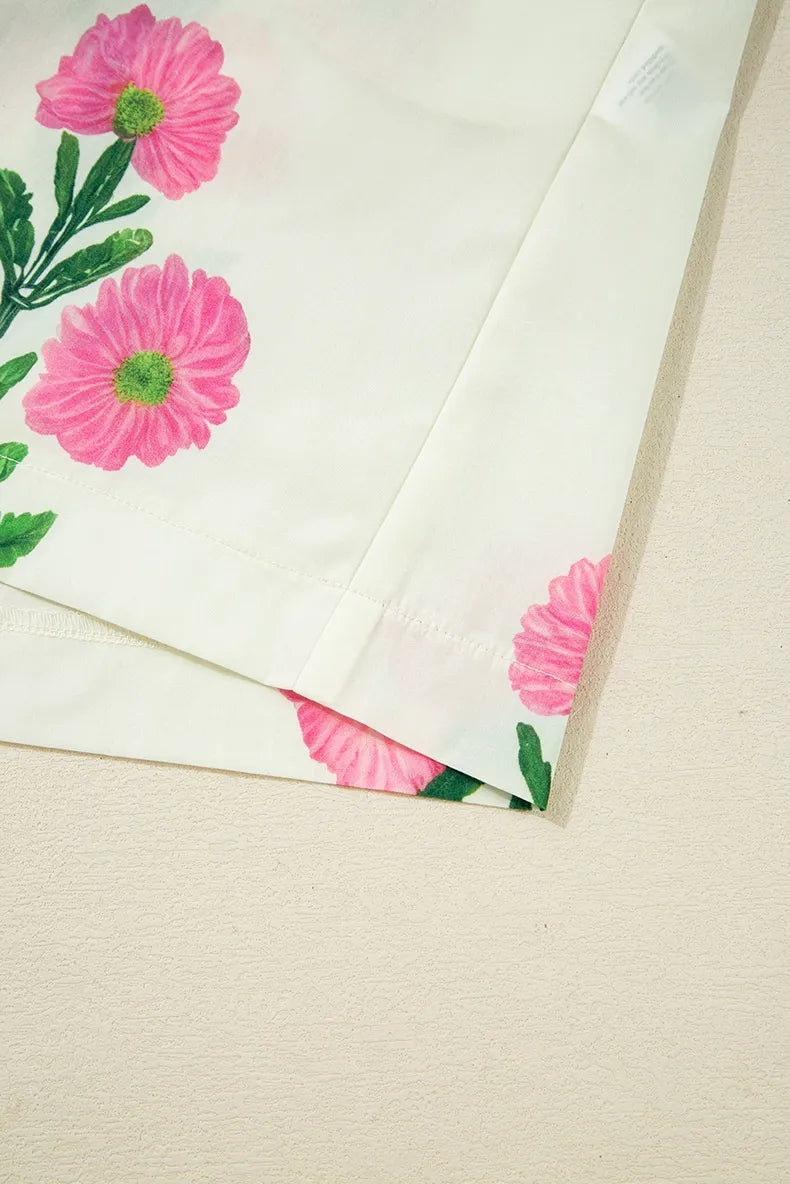 Floral-patterned paper with pink flowers and green leaves on a beige background