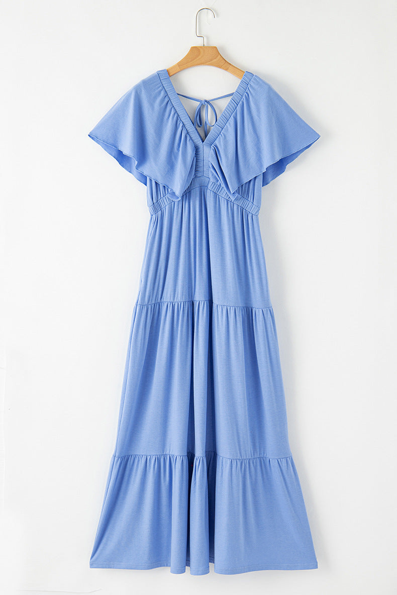 Blue dress on a hanger against a white background