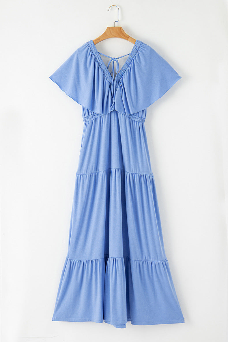 Blue dress on a hanger against a white background