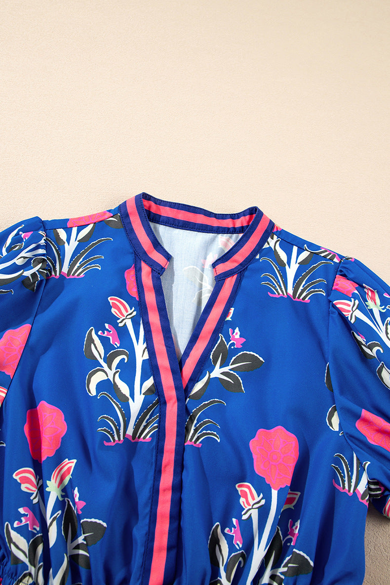 Blue floral-patterned jacket with pink accents on a beige background