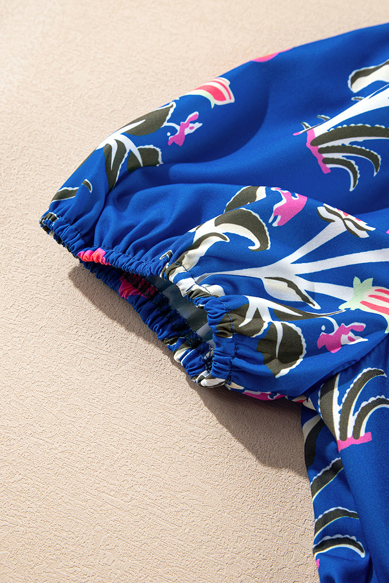 Blue swim trunks with a colorful dolphin pattern on a beige surface