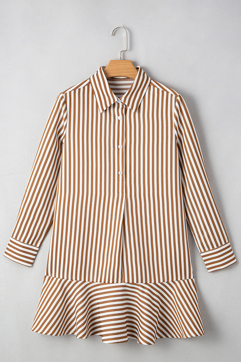 Brown and white striped dress on a hanger against a gray background