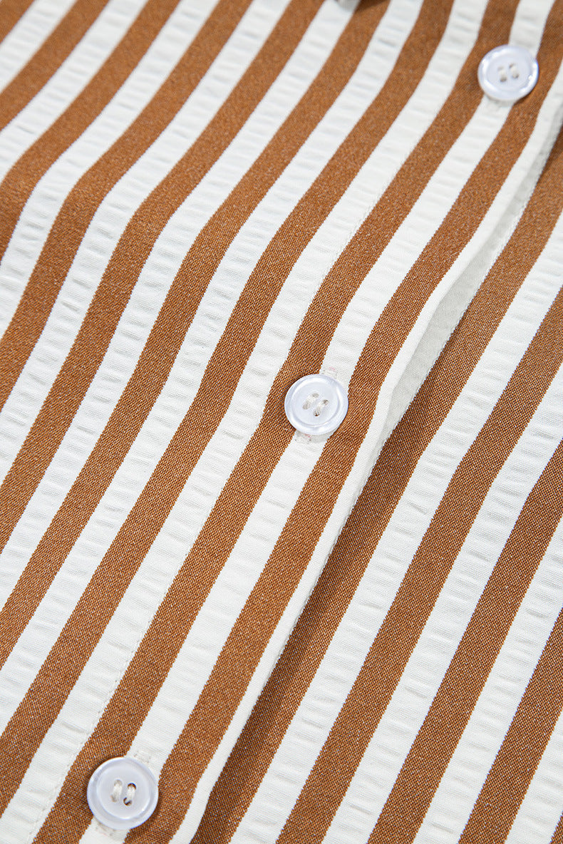 Close-up of a brown and white striped shirt with buttons.