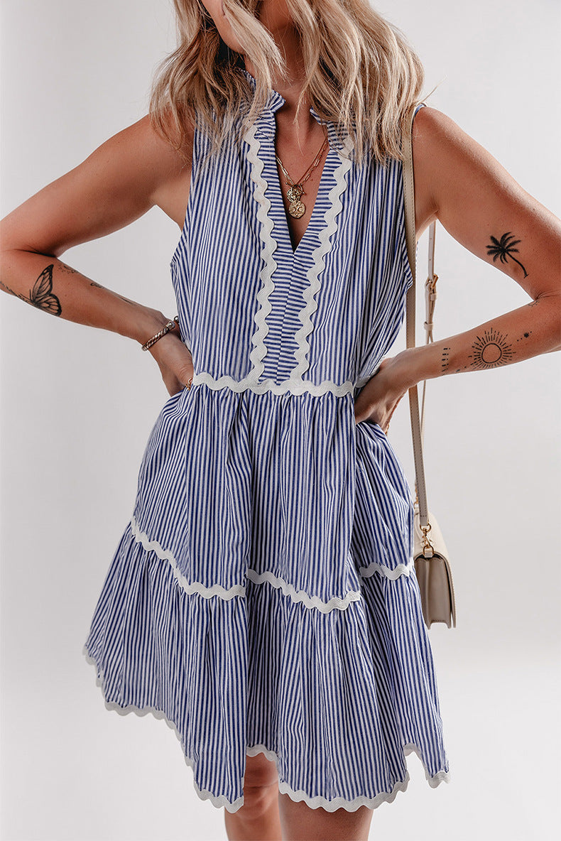 Woman wearing a blue and white striped dress with a plain background